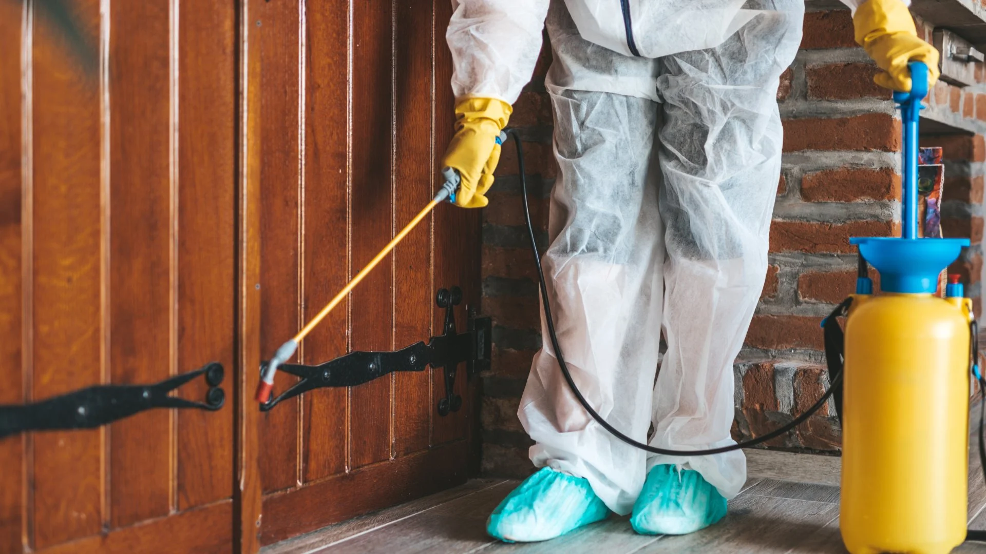 Perimeter pest control being applied by front door in Austin, TX.