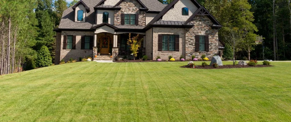 Brown house in Austin, TX, with a manicured front lawn.