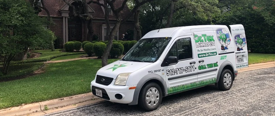 White van of a pest control team by a house in Austin, TX.