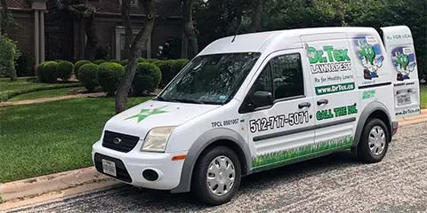 Dr. Tex Lawn & Pest service van in front of a home in Austin, Texas.